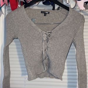 gray sweater material shirt, adjustable stings in the front, stretchy